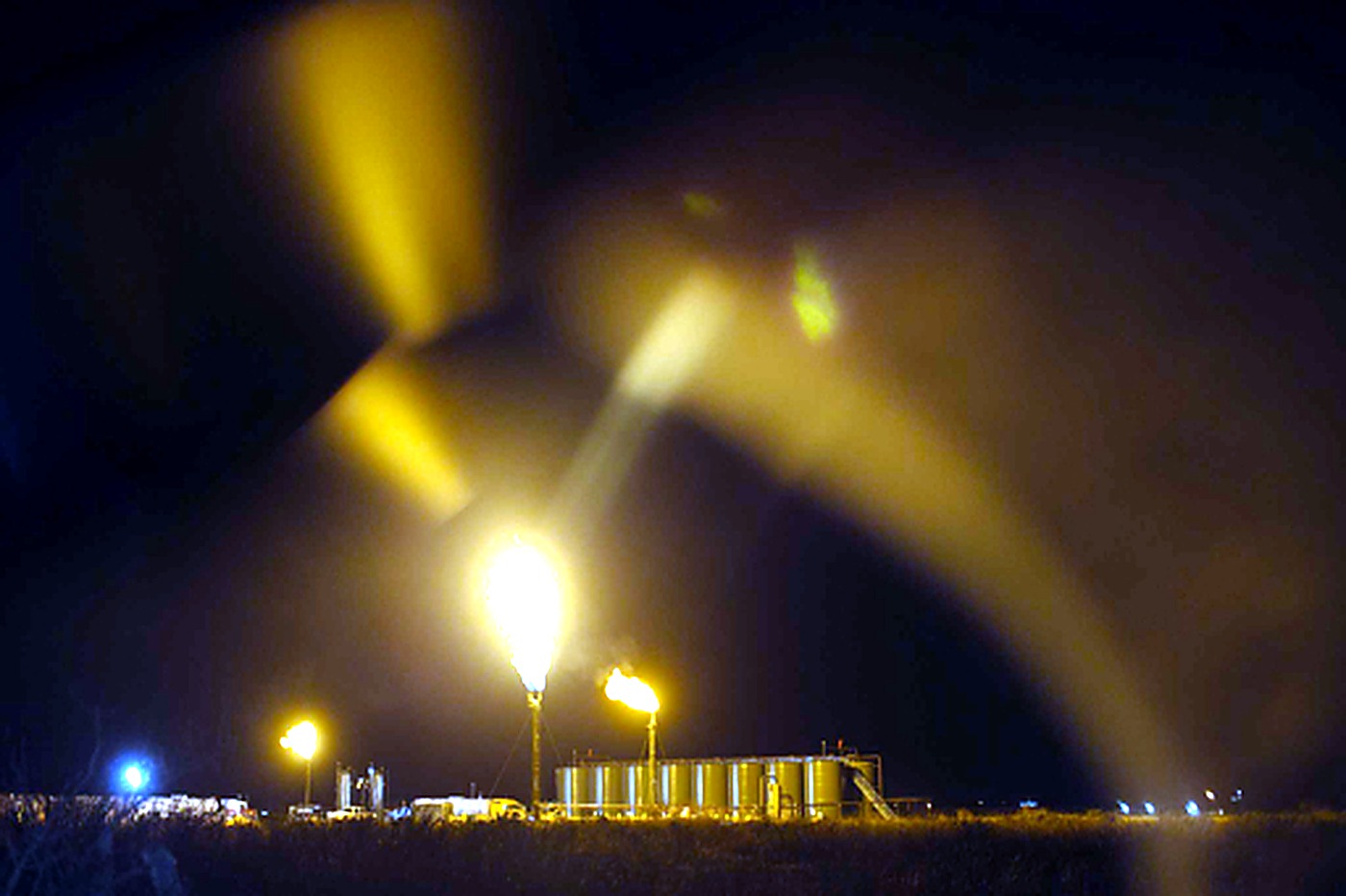 District 08 oilfield operations and flare stacks at night